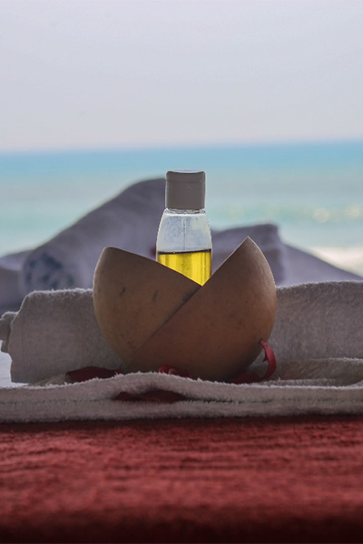 Massage oils and fresh towels prepared for a Moonga session
